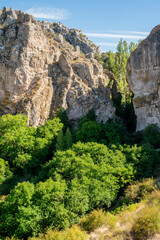 Arroyo Boqueron, Valle de Tabladillo, Segovia. limestone rock mountain with green trees
