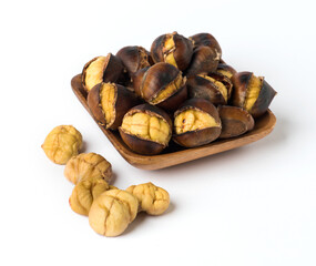 Roasted chestnut on wooden plate.