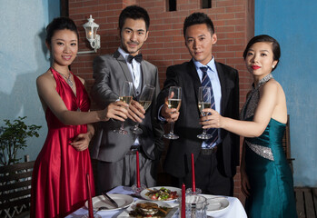 Four people sit together for dinner and chat