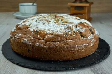 Cake with coffee on wooden table