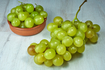 Green grapes on wooden table