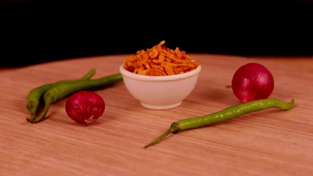khatta meetha namkeen mixture(frali) with onion and chili peppers,Indian morning or tea-time snacks like bhakharvadi , chivda, farsan, mixture, shing bhujia, bakarwadi etc served in white wooden box