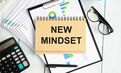New mindset text on grey cork notice board with pencils. Flexible and innovative work approach. Success management concept