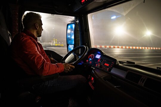 The driver at the wheel of the truck. Night course.