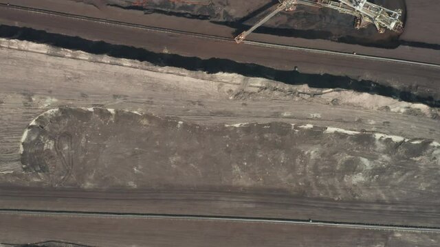 Flight over the quarry with heavy bucket wheel excavators mining a coal. Heavy industry concept. 