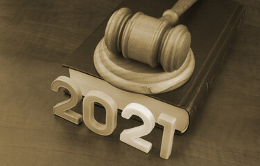 Wooden judge gavel, legal book and numbers 2021. New laws and rules in year 2021.
