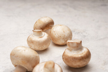 A few mushrooms on a light stone table