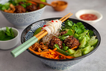 Side view of a Vietnamese bowl of rice noodles with vegetables also known as bun cha