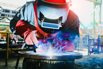 worker with Torch head Mig Mag, Operator welding machine metal steel pipe by MIG welding - obrazy, fototapety, plakaty