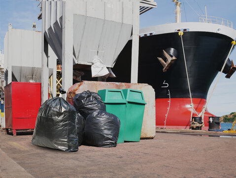 Garbage bags and trash can on the floor in the shipyard.