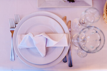 Serving, setting table. Two plates and silverware cutlery linen napkin. Wedding table decoration....