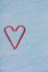 Festive blue background. Heart of sweet candies. Christmas card. Valentine Day. 14 of February. Flat lay, top view.