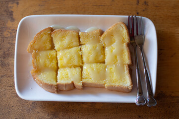 Bread with butter and sugar on a white plate