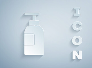 Paper cut Hand sanitizer bottle icon isolated on grey background. Disinfection concept. Washing gel. Alcohol bottle for hygiene. Paper art style. Vector Illustration.