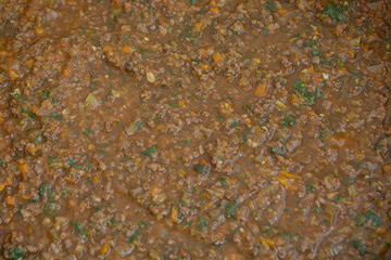 Close up view of an homemade Bolognese sauce (Ragù alla Bolognese) with fresh basil (Ocimum Basilicum)