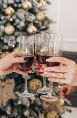 The girls drink champagne and enjoy the holiday. Festive mood. New Year's and Christmas. Cheers!