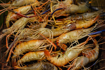 The grilled shrimp on the stove are about to be ready to eat.
