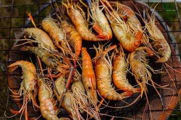 The grilled shrimp on the stove are about to be ready to eat.