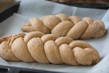 Fototapeta premium Traditional prebaked Challah bread, made of spelt flour, with topping of sesame and poppy seeds