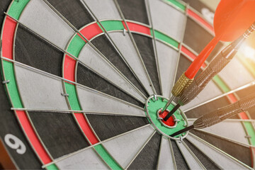Arrow hit the target with light on sunset background, the game focuses on success, planning to be smart concept.