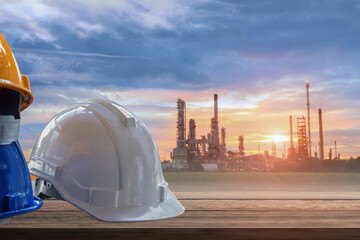 Engineering management construction, engineer hold in hand white helmet for workers security site background, business concept on oil refinery background.