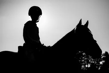 Foto auf Leinwand boy riding horse silhouette © Jesse