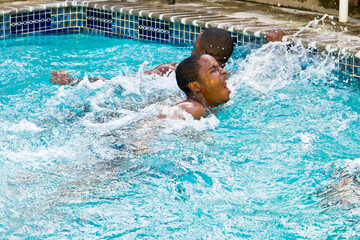 Father, son and the big race in the backyard swimming pool - agony of defeat - 402686124