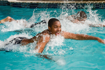 father, teen son and the big race in the backyard swimming pool - 402686165