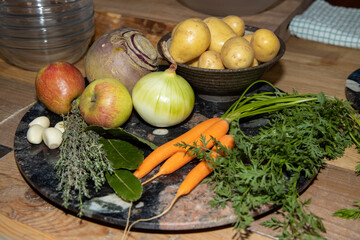 A plate of uncooked vegetables on a kitchen work top