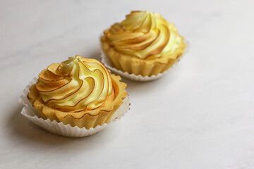 Tasty lemon tart with meringue on light background