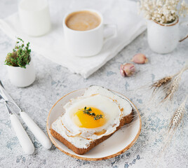 Breakfast of toast with fried egg on a plate, selective