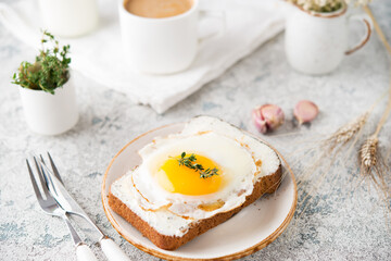 Breakfast of toast with fried egg on a plate, selective
