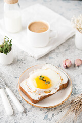 Breakfast of toast with fried egg on a plate, selective