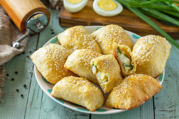 Ukrainian or Russian cuisine. Baked small pies with egg and green onions, spring vitamin baked goods.