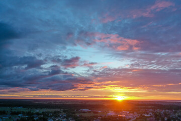 Aerial view of a beautiful sunset sky, colorful clouds, sun rays