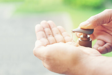 Hand pushing pumping head bottle of gel or soap or hand sanitizer and contain droplet gel in hand. Concept hygiene of prevent COVID-19 spread Coronavirus and individual prevention.