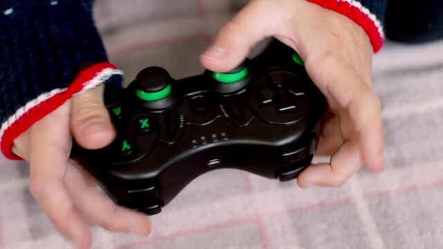 children's hands close-up with a joystick. The concept of game consoles.