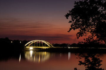 Naklejka premium Illuminated Bridge over Rio Preto at Sunset on the Municipal Reservoir in São José do Rio Preto, Brazil