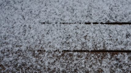 Snow-covered decking. Wood deck during snow time in winter.