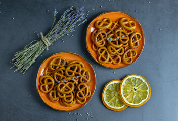 Delicious crackers, lavender and orange on a concrete background.