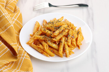 Food - Delicious Penne Pasta Plate with a Fork on White Marble Background