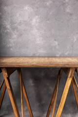 wooden table near concrete wall background