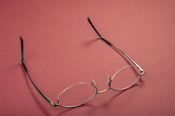 New metal glasses frame on a red background