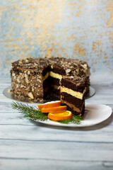 cake on a plate with orange chocolate filling on a light wooden background