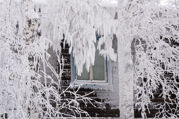 Frozen window of an old wooden residential building