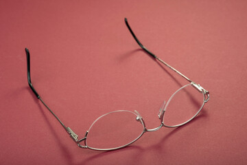 New metal glasses frame on a red background