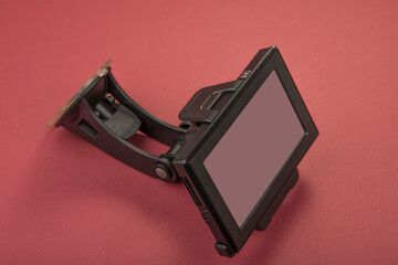 Old GPS navigation on a red background