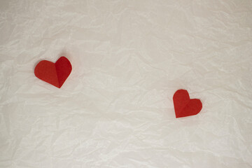 hearts made of paper for valentine's day on crumpled background with copy space
