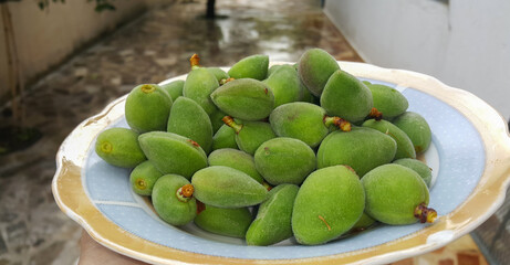 Close up of Fresh green almonds in a plate
