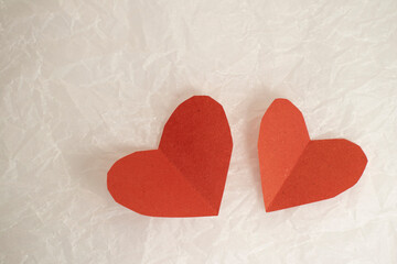 hearts made of paper for valentine's day on crumpled background with copy space